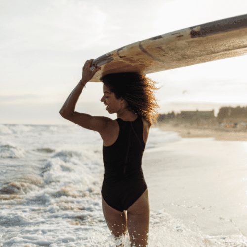 girl with surfboard on her head